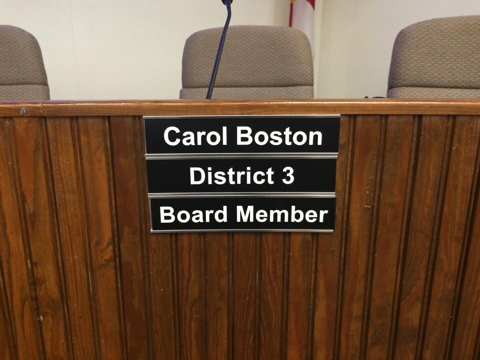 Carol Boston District 3 Board Member nameplate at the dais