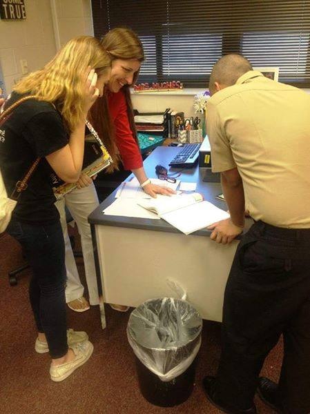 Carol Boston helping students at a school desk