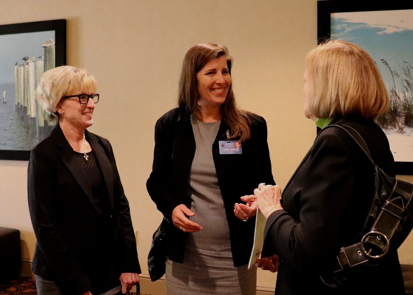 Carol Boston in professional conversation at a networking event