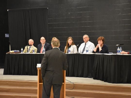 Carol Boston seated at a school board panel session