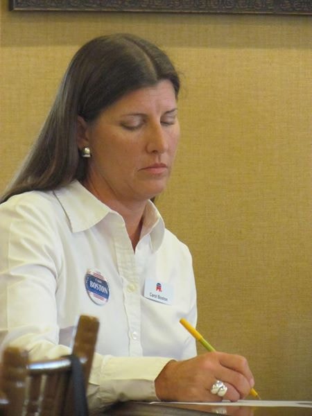 Carol Boston taking notes at a community meeting