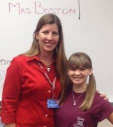 Mrs. Boston with a student in the classroom